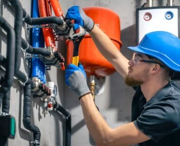 man-installs-heating-system-house-checks-pipes-with-wrench_169016-55834