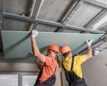 workers-are-lifting-plasterboard-further-attaching-ceiling_191163-1454