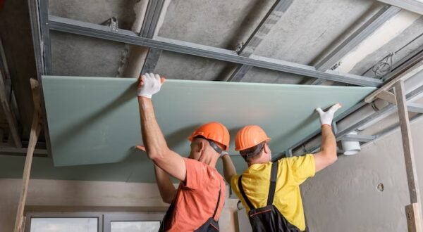 workers-are-lifting-plasterboard-further-attaching-ceiling_191163-1454